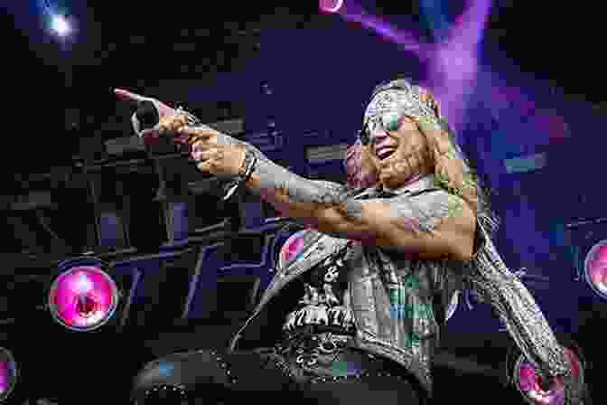 Steel Panther Performing On Stage, With Michael Starr On Vocals And Satchel On Guitar. The Rise Fall And Rebirth Of Hair Metal